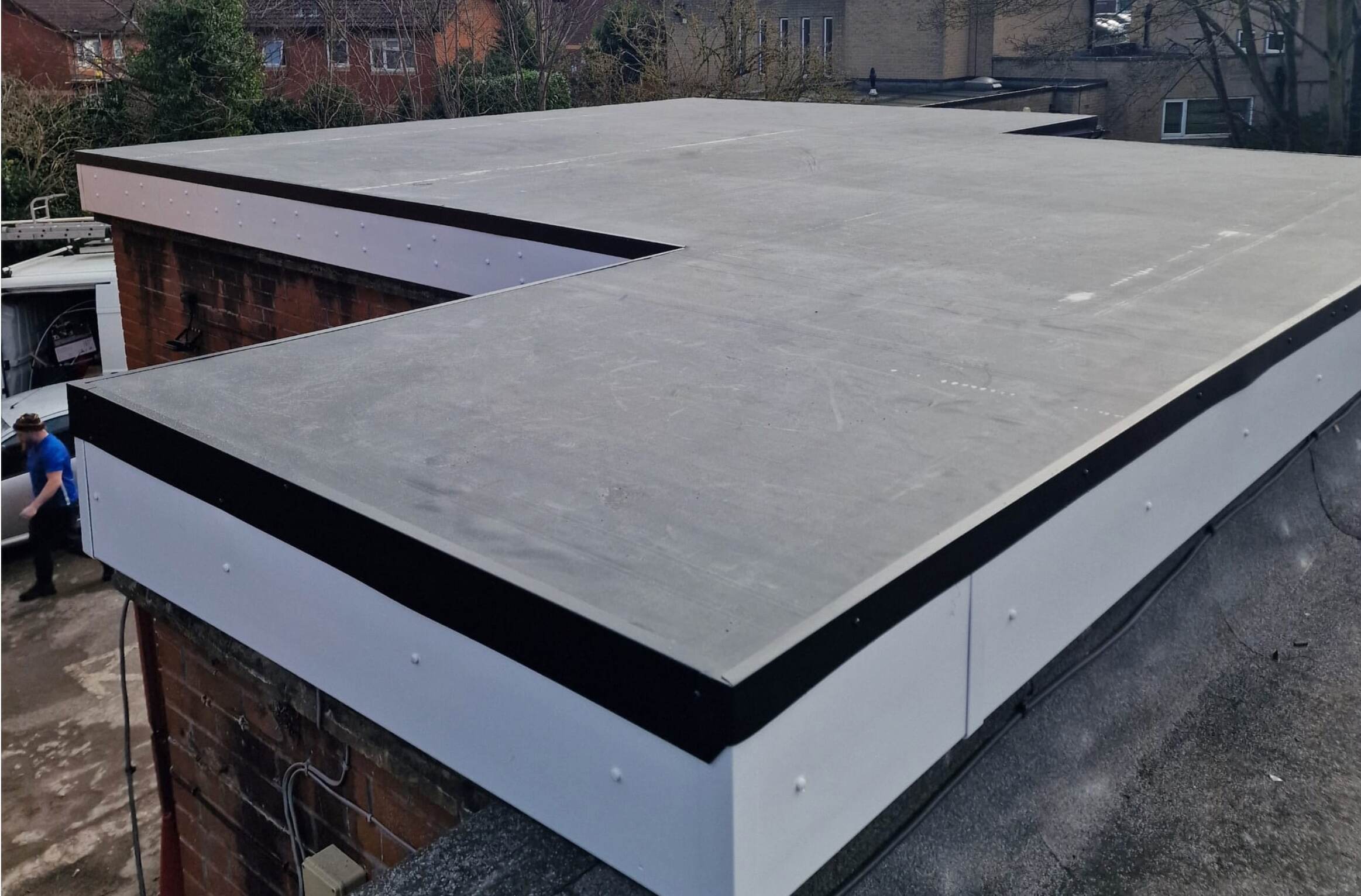 How does drainage work on a flat roof?